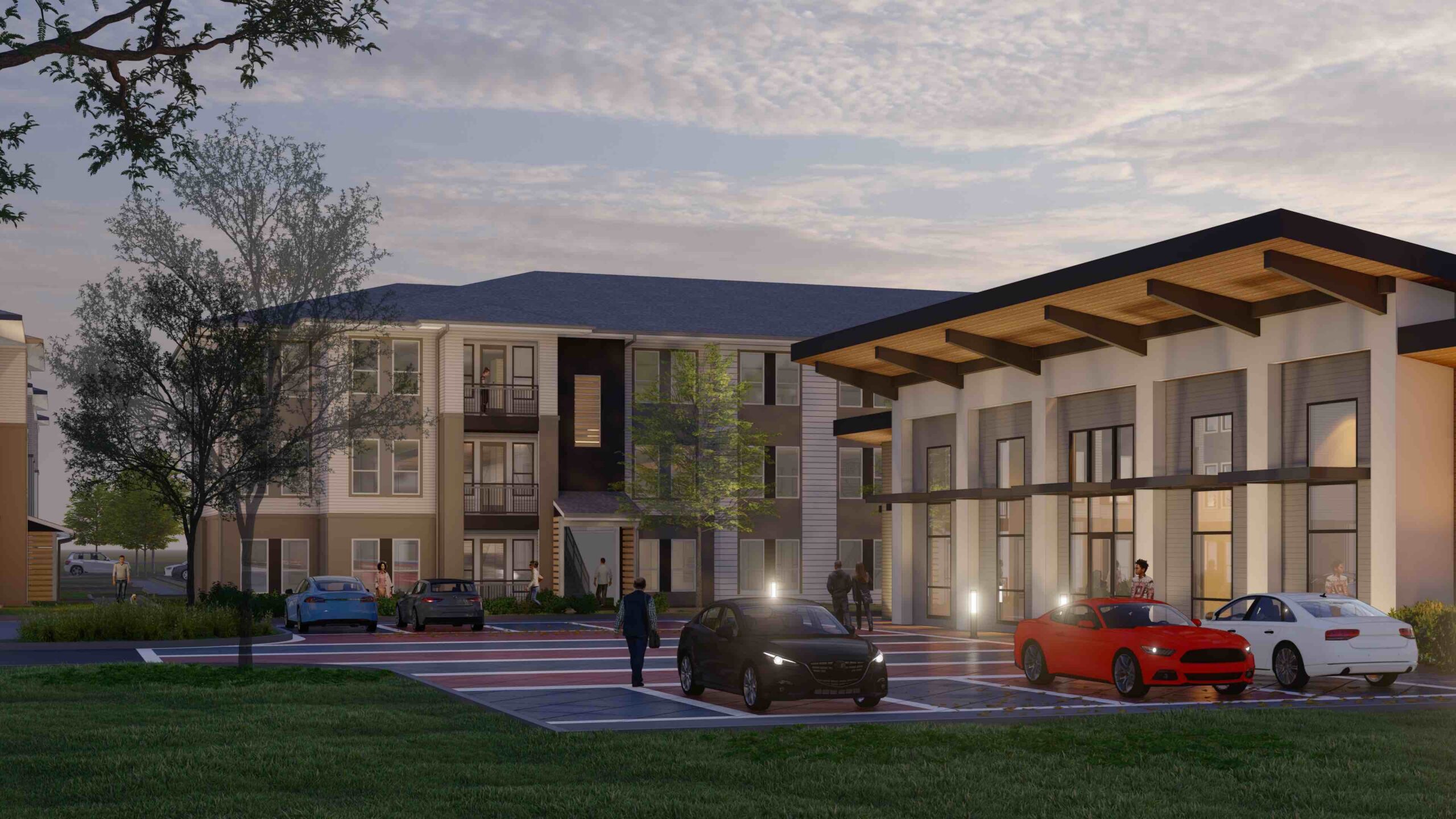A modern apartment complex with a parking lot in front, several cars parked, and a few people walking near the buildings at sunset.